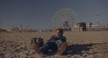 Caught Stealing_Hank sleeps on the beach
