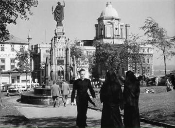 I Confess_Father Logan strolls through the park
